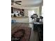 Open living room and kitchen featuring dark cabinetry and modern appliances at 30386 N Juniper Dr, Florence, AZ 85132
