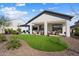 Backyard featuring artificial grass, patio, and lush landscaping; perfect for outdoor living and entertaining at 3074 N 167Th Dr, Goodyear, AZ 85395