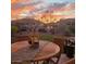 Outdoor dining area with a wooden table, chairs, and a lantern, creating a cozy and inviting atmosphere at 3074 N 167Th Dr, Goodyear, AZ 85395