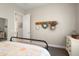 Bright bedroom with a view to the bathroom featuring neutral paint, and a decorative wreath on the wall at 3074 N 167Th Dr, Goodyear, AZ 85395