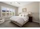 Comfortable bedroom features large windows, plantation shutters, soft lighting, and neutral decor at 3074 N 167Th Dr, Goodyear, AZ 85395