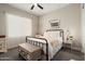 Charming bedroom featuring a wrought iron bed frame, soft natural light, and a decorative storage chest at 3074 N 167Th Dr, Goodyear, AZ 85395