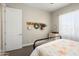 Well-lit bedroom with neutral colors, featuring a view of the bright outdoors and decorative appointments at 3074 N 167Th Dr, Goodyear, AZ 85395