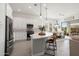 Open kitchen featuring an island with seating, modern appliances, and an adjacent dining area at 3074 N 167Th Dr, Goodyear, AZ 85395