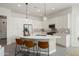 Bright, modern kitchen with a curved island, pendant lights, and stainless steel appliances at 3074 N 167Th Dr, Goodyear, AZ 85395