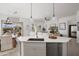 Bright kitchen features stainless steel appliances, stone countertops, and views to Gathering room and backyard at 3074 N 167Th Dr, Goodyear, AZ 85395