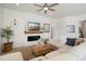 Inviting living room featuring fireplace, ceiling fan, and comfortable seating area at 3074 N 167Th Dr, Goodyear, AZ 85395