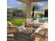 Relaxing outdoor living space with comfortable seating, an area rug, and a view of the green landscaping at 3074 N 167Th Dr, Goodyear, AZ 85395