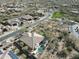 A high-angle view reveals a home with a private pool and putting green in a desert neighborhood at 32742 N 15Th Gln, Phoenix, AZ 85085