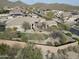 A beautiful home with a lawn in the backyard, complemented by desert plants and stunning views at 32742 N 15Th Gln, Phoenix, AZ 85085
