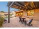 Cozy backyard patio with a covered pergola, a dining area, and a view of the sparkling pool for outdoor enjoyment at 32742 N 15Th Gln, Phoenix, AZ 85085