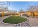 Expansive backyard with artificial turf, desert landscaping, providing a secure and serene outdoor environment at 32742 N 15Th Gln, Phoenix, AZ 85085