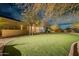 View of the backyard, featuring a well manicured lawn, desert landscaping, and privacy fence at 32742 N 15Th Gln, Phoenix, AZ 85085