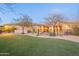 Beautiful backyard with artificial turf and desert landscaping and black metal fenced border at 32742 N 15Th Gln, Phoenix, AZ 85085