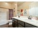 Bathroom featuring a double vanity, dark wood cabinets, and a shower/tub combo with a colorful curtain at 32742 N 15Th Gln, Phoenix, AZ 85085