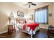 Cozy bedroom featuring a decorative mirror, and a ceiling fan for added comfort at 32742 N 15Th Gln, Phoenix, AZ 85085