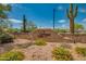 The community center rock sign sits among desert landscaping and Saguaro cactus under a brilliant blue sky at 32742 N 15Th Gln, Phoenix, AZ 85085
