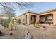 Courtyard showcasing desert landscaping with metal artwork, covered patio, and wrought iron fence at 32742 N 15Th Gln, Phoenix, AZ 85085