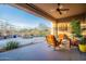 Inviting covered patio lounge area next to the sparkling pool and desert landscaping at 32742 N 15Th Gln, Phoenix, AZ 85085