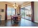 Dining area with a view of the outdoor pool and lounge area through large sliding doors at 32742 N 15Th Gln, Phoenix, AZ 85085