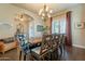 Bright dining room featuring a modern chandelier, wood table and floors, and stylish decor at 32742 N 15Th Gln, Phoenix, AZ 85085