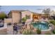 Exterior view of the home with a swimming pool and a covered patio with cafe lights at 32742 N 15Th Gln, Phoenix, AZ 85085