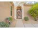 Inviting front entrance with a decorative metal gate and lush desert landscaping at 32742 N 15Th Gln, Phoenix, AZ 85085