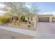 Charming single-story home featuring desert landscaping, an attached two-car garage and shade tree at 32742 N 15Th Gln, Phoenix, AZ 85085