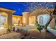 Charming single-story home featuring desert landscaping, an arched entryway, and decorative metal sculptures at 32742 N 15Th Gln, Phoenix, AZ 85085
