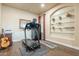 Home gym with a treadmill, guitar, and glass shelves at 32742 N 15Th Gln, Phoenix, AZ 85085