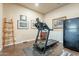 Home gym features a treadmill and a decorative wooden ladder leaning against the wall at 32742 N 15Th Gln, Phoenix, AZ 85085