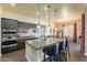 Gourmet kitchen with large island, granite countertops, and stainless steel appliances at 32742 N 15Th Gln, Phoenix, AZ 85085