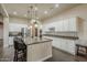 Bright, modern kitchen with an island, stainless steel appliances, white cabinetry, and ample counter space at 32742 N 15Th Gln, Phoenix, AZ 85085