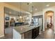 Open-concept kitchen with granite counters, stainless steel appliances, and view of the living room at 32742 N 15Th Gln, Phoenix, AZ 85085