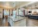 Kitchen island sink overlooks the dining and living areas, creating an open and integrated living space at 32742 N 15Th Gln, Phoenix, AZ 85085