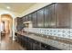 Gourmet kitchen featuring granite countertops, custom backsplash, and stainless steel appliances at 32742 N 15Th Gln, Phoenix, AZ 85085