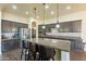 Modern kitchen with dark cabinetry, stainless steel appliances, and a granite countertop island at 32742 N 15Th Gln, Phoenix, AZ 85085