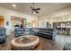 Open-concept living room with a large sectional sofa and stylish coffee table at 32742 N 15Th Gln, Phoenix, AZ 85085