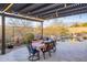 Covered patio dining area with table and seating next to a sparkling pool and desert landscaping at 32742 N 15Th Gln, Phoenix, AZ 85085