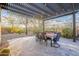 Outdoor dining area with a pergola, cafe lights, and desert landscaping at 32742 N 15Th Gln, Phoenix, AZ 85085