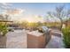 Outdoor kitchen with grill and a dining area next to a sparkling pool and desert landscaping at 32742 N 15Th Gln, Phoenix, AZ 85085