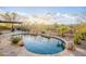 Beautiful pool with a rock waterfall feature, surrounded by desert landscaping, creating a relaxing outdoor oasis at 32742 N 15Th Gln, Phoenix, AZ 85085