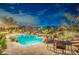 Inviting backyard pool area with a waterfall feature and covered patio with string lights at 32742 N 15Th Gln, Phoenix, AZ 85085