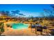 Relaxing pool area with rock waterfall feature and a dining space at 32742 N 15Th Gln, Phoenix, AZ 85085