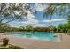 A resort style pool is surrounded by desert landscaping with blue skies and a covered seating area at 32742 N 15Th Gln, Phoenix, AZ 85085