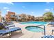 Inviting community pool and hot tub surrounded by cozy lounge chairs and contemporary residential buildings at 3500 N Hayden Rd # 2201, Scottsdale, AZ 85251