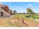 View of a golf course, and a modern residential building with a beautiful landscape on a sunny day at 3500 N Hayden Rd # 2201, Scottsdale, AZ 85251
