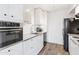 Modern kitchen with stainless steel appliances, sleek white cabinetry, and efficient use of space at 3500 N Hayden Rd # 2201, Scottsdale, AZ 85251