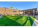 Lush backyard featuring a luxurious hot tub, an outdoor kitchen area, and a recreational sport area at 3840 W Brogan Ct, New River, AZ 85087
