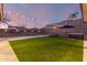 This backyard features a tennis court, a hot tub, and a lush green lawn that is perfect for recreation at 3840 W Brogan Ct, New River, AZ 85087